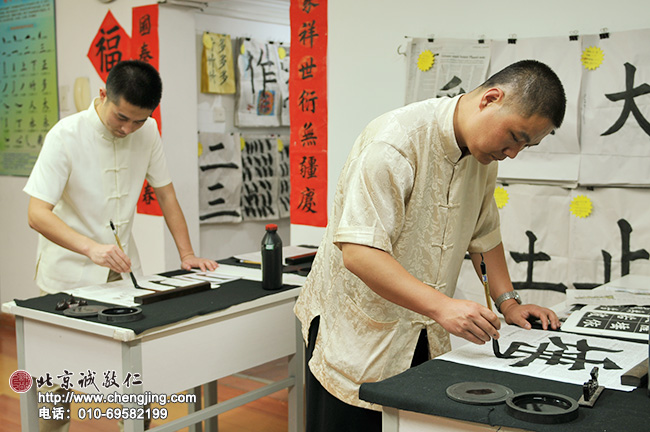 書法教室的輔導老師們聽過楊老師給學員的耐心講解之后，在一旁精益求精的體會剛剛的指導。